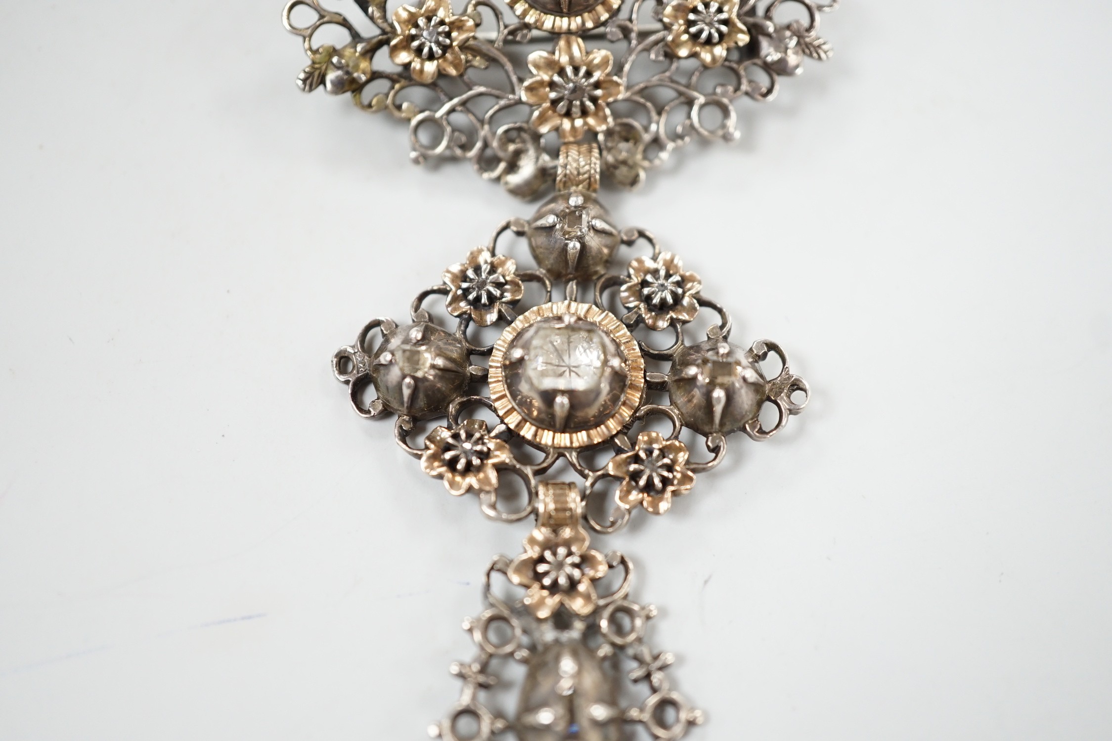 A continental antique pierced white and yellow metal, diamond set three tier drop brooch, 70mm, gross weight 13.2 grams.